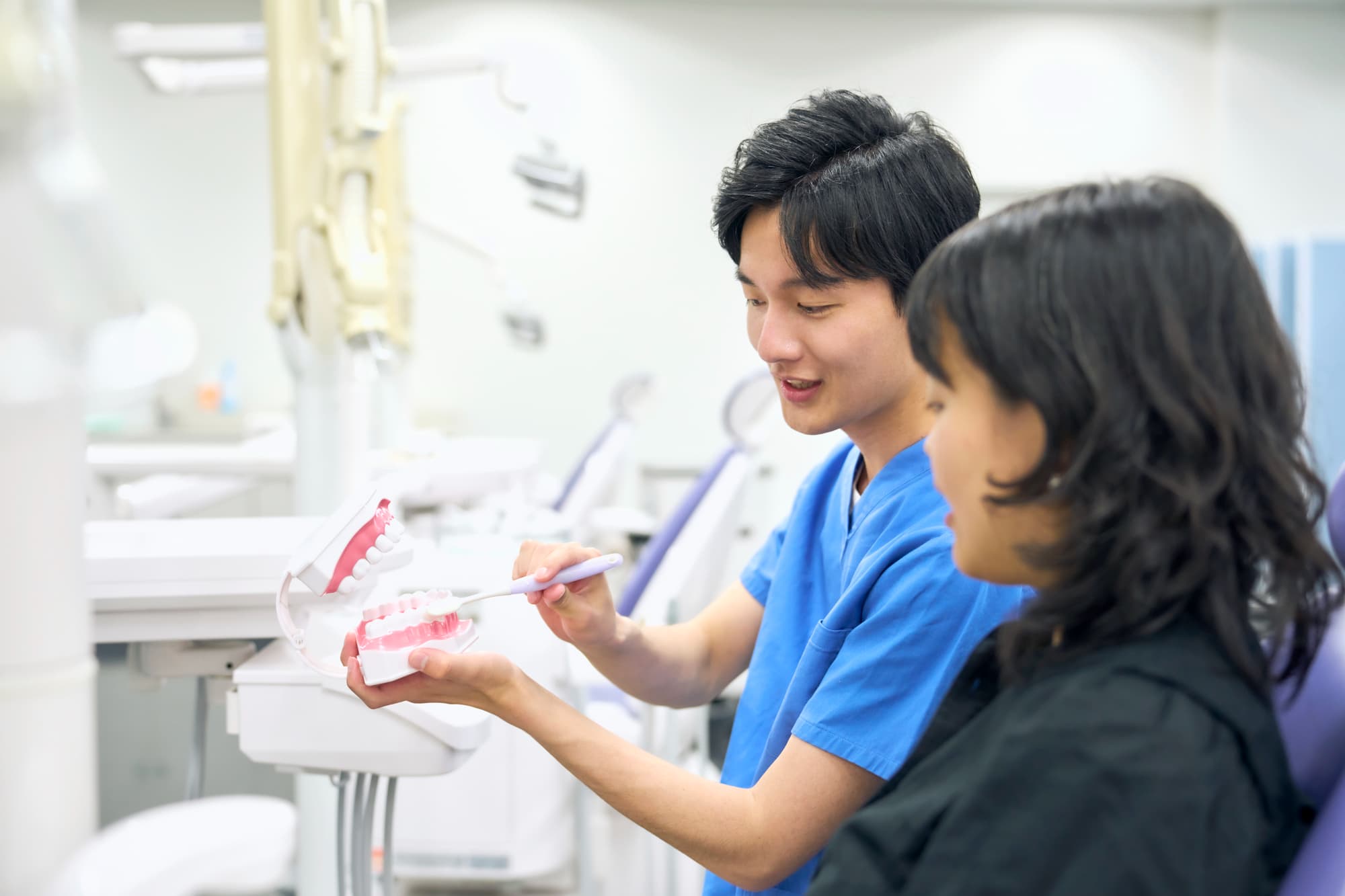 インプラント治療後の歯磨きの仕方を歯科医から教わる患者